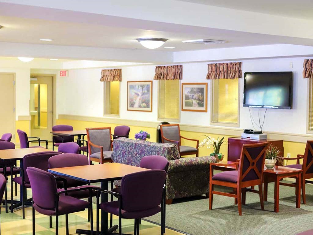 a dining room with tables and chairs and a television