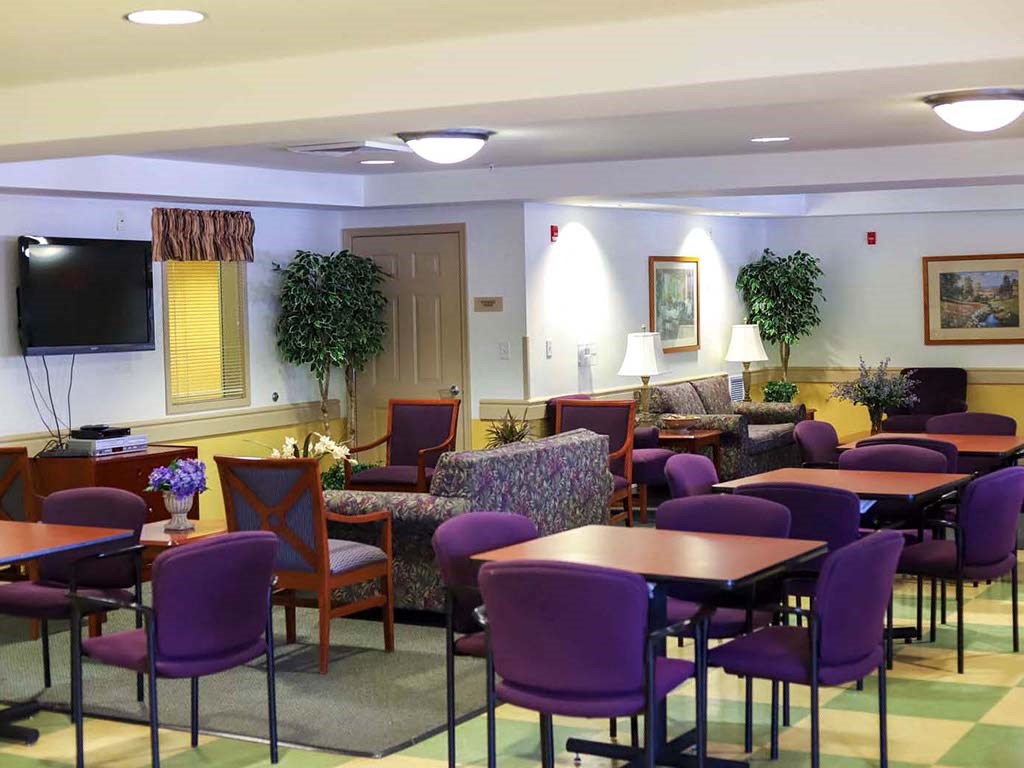 a dining room with tables and chairs and a tv