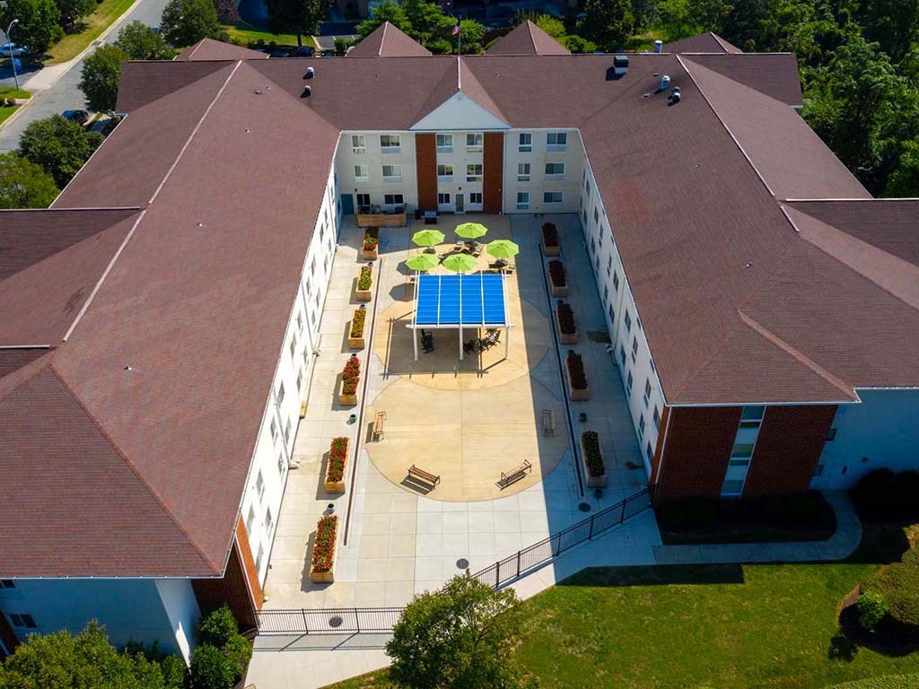 an aerial view of the courtyard of a building with a blue pool