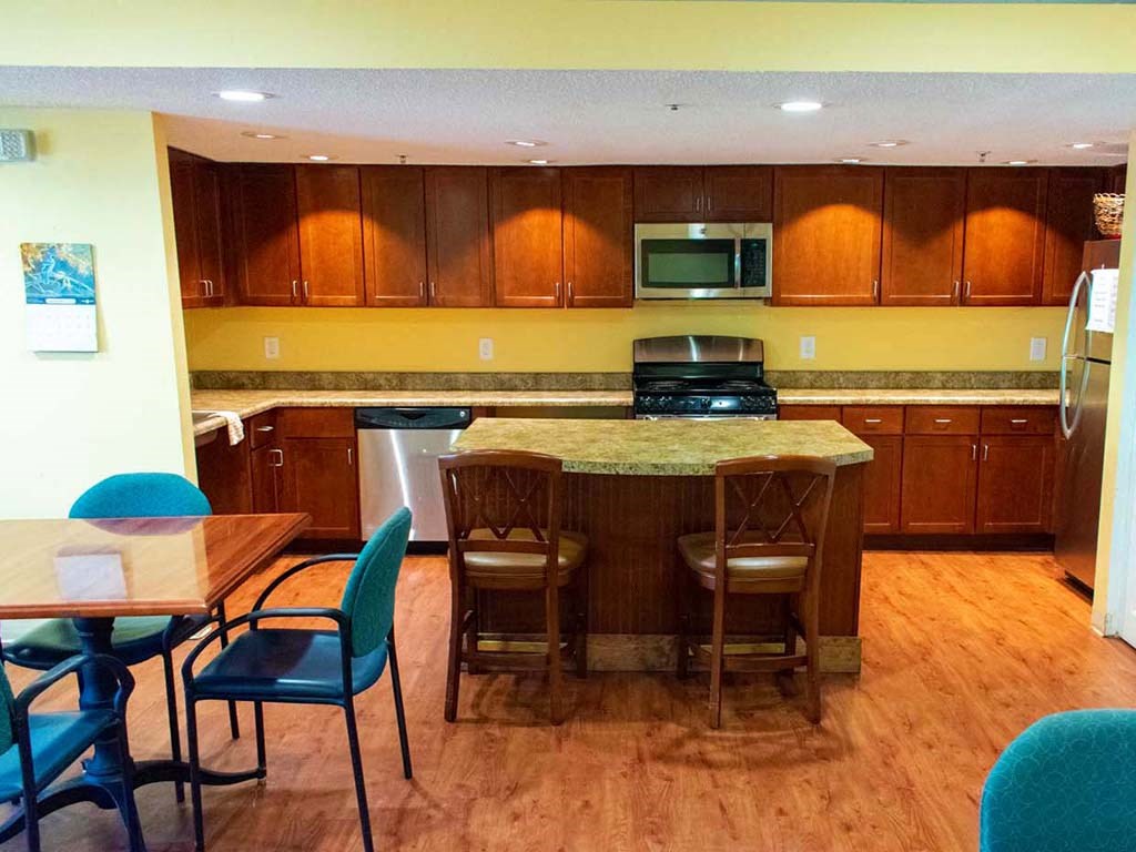 a kitchen with an island and a table with chairs