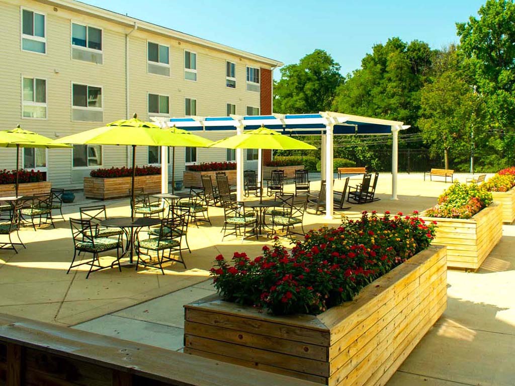 an outdoor patio with tables and chairs and umbrellas