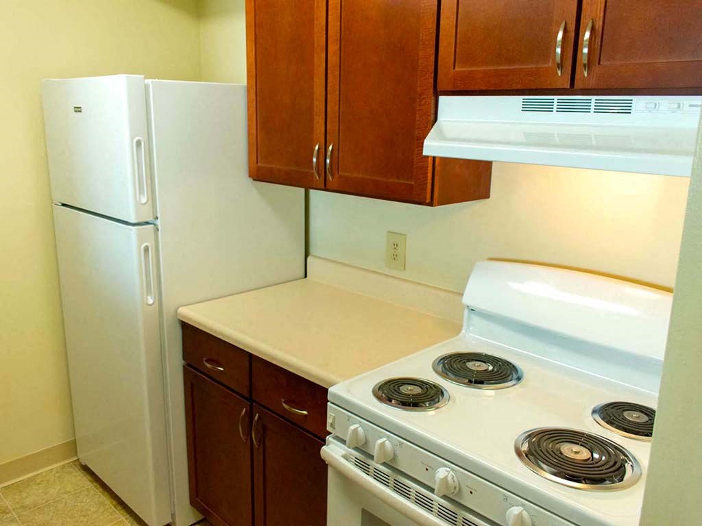 a kitchen with a stove and a refrigerator