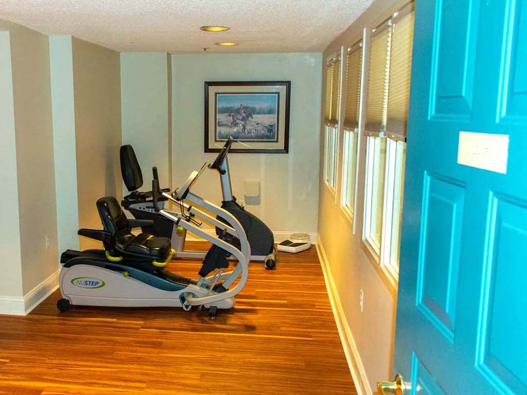 a gym room with a exercise bike in it