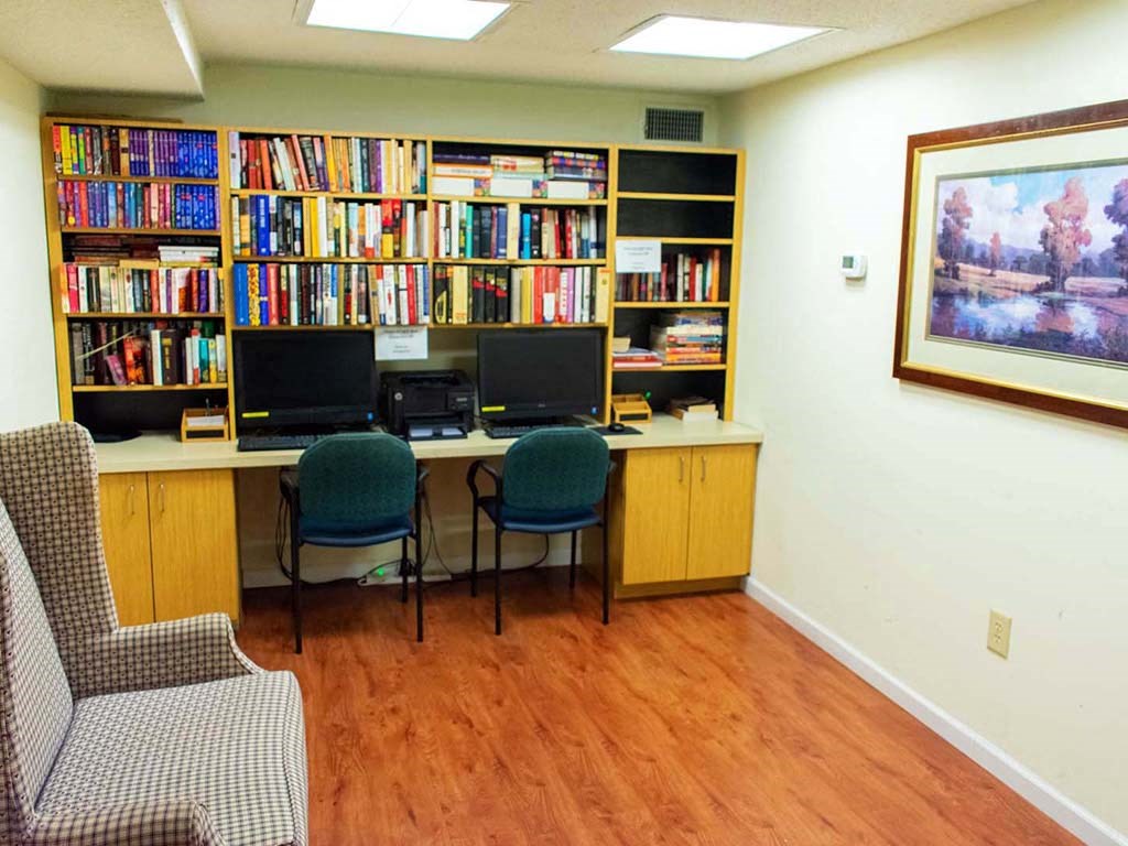 a library with desks and chairs and bookshelves