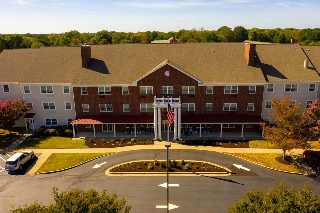 an aerial view of a building with an flag in front of it