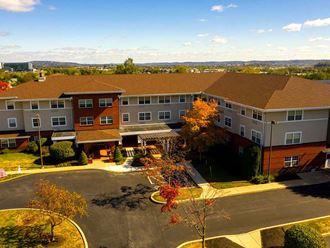 an aerial view of a large building in a parking lot