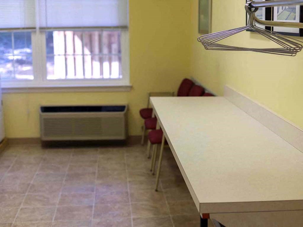 a kitchen with a long counter and a window