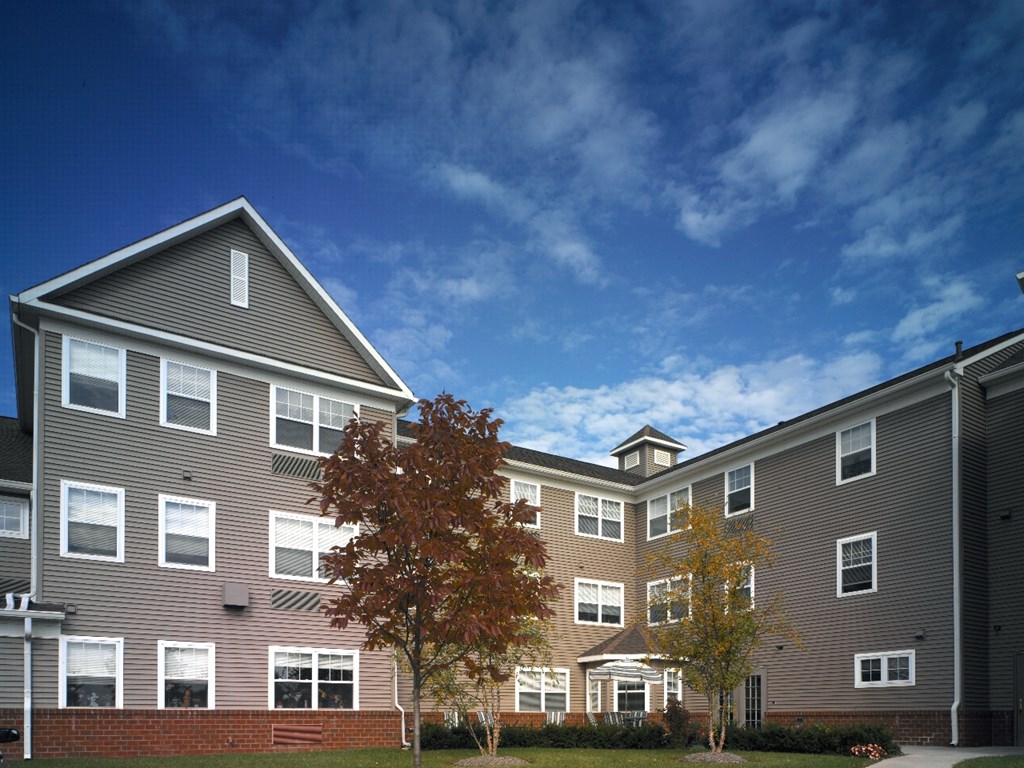 the exterior of an apartment building on a sunny day