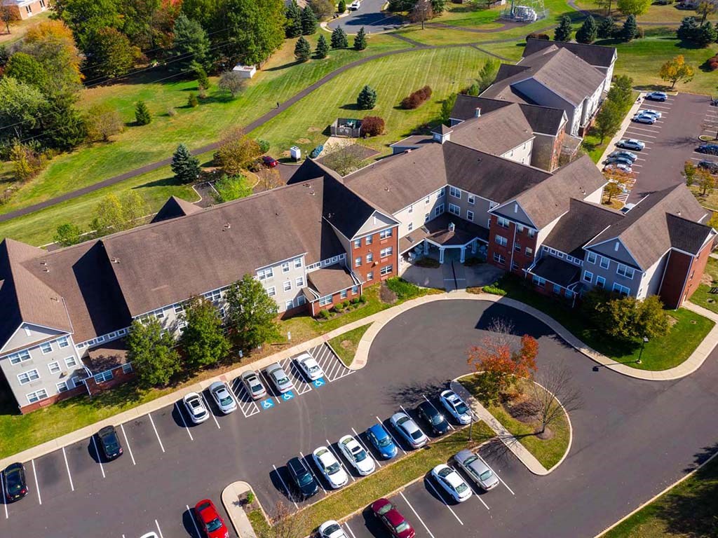 an aerial view of a large building with cars parked in a parking lot