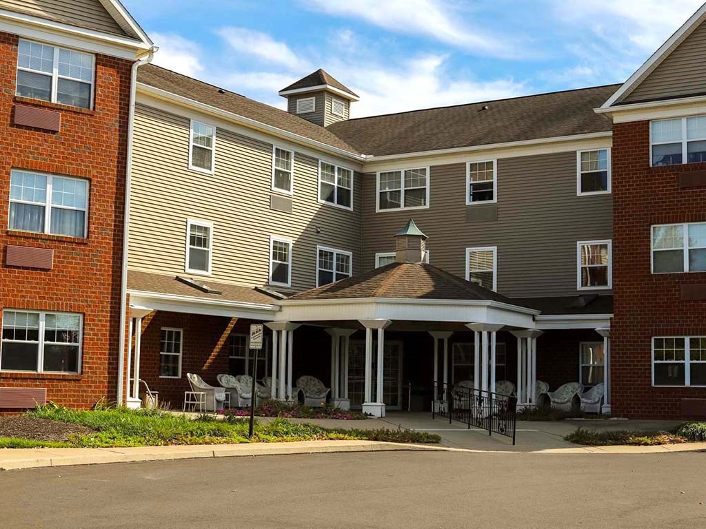 a building with a patio and chairs in front of it