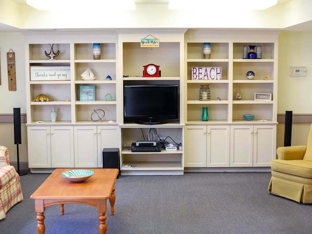 a living room with a coffee table and a television