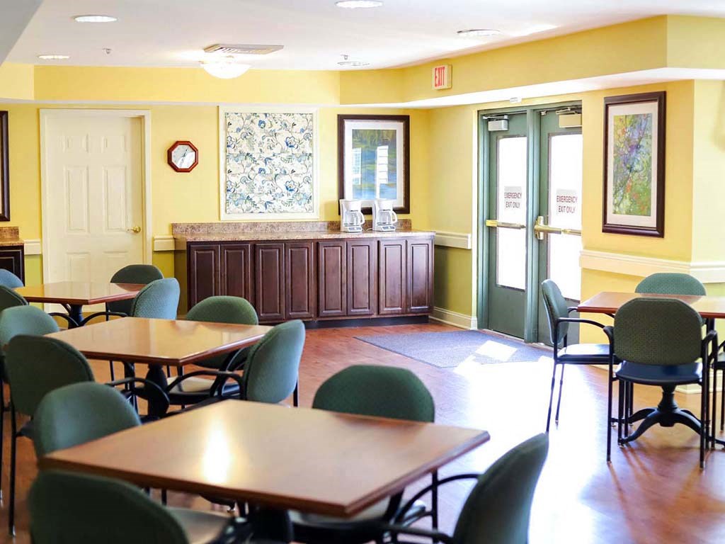 a dining room with tables and chairs and a counter