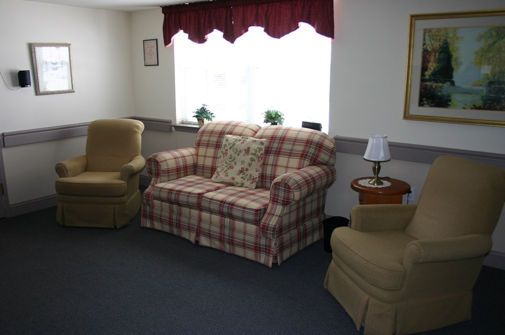 a living room with two chairs and a couch