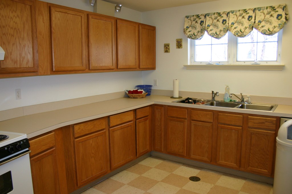 a kitchen with wooden cabinets and a sink