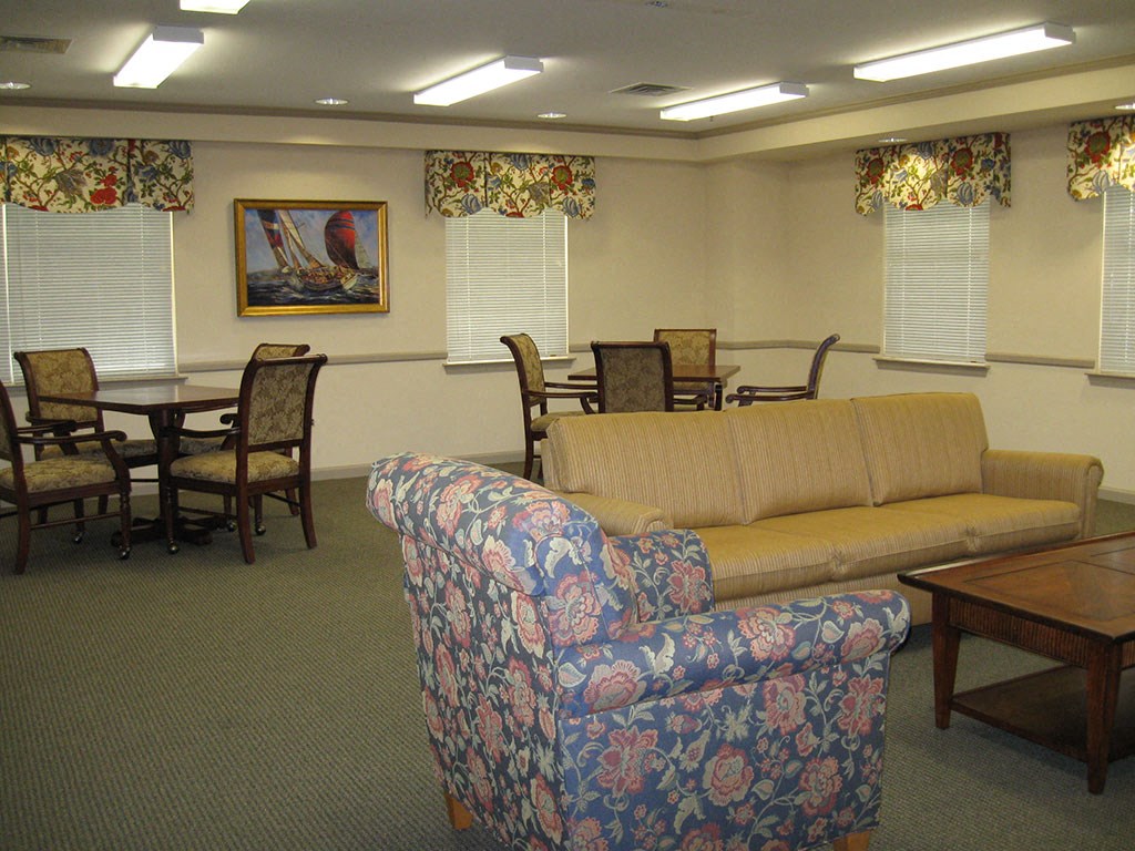 a common room with a couch and chairs and a table