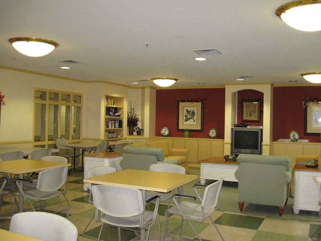 a dining room with tables and chairs and a television