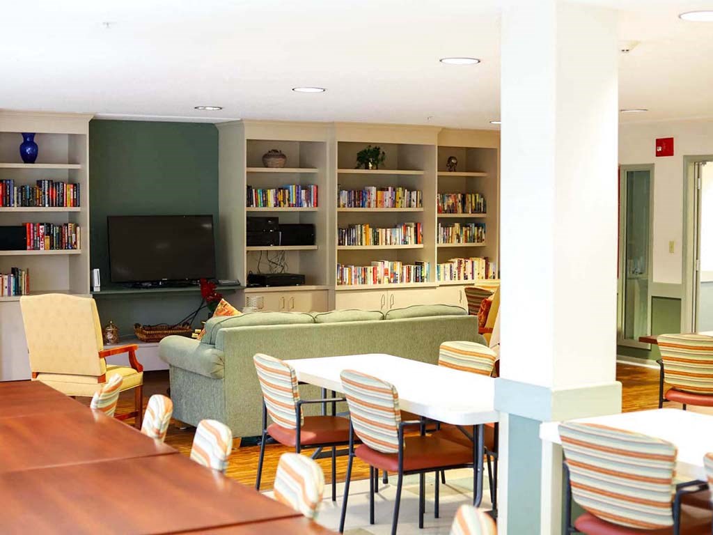 a living room with a table and chairs and a television