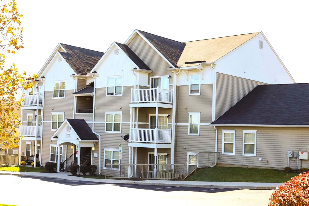 an apartment building with a street in front of it