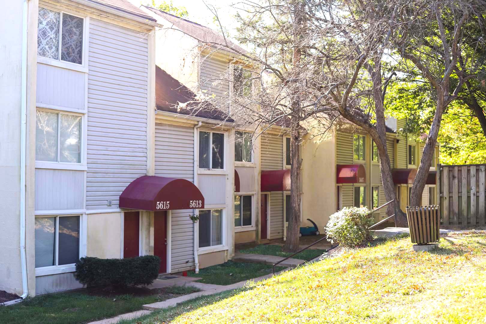 a side view of a house with a yard and a sidewalk