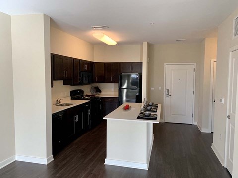 a kitchen with black appliances and a white counter top