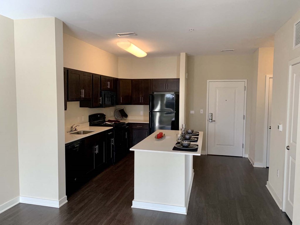 Sleek, modern kitchen with large island at Metro Heights apartment community near downtown Baltimore.