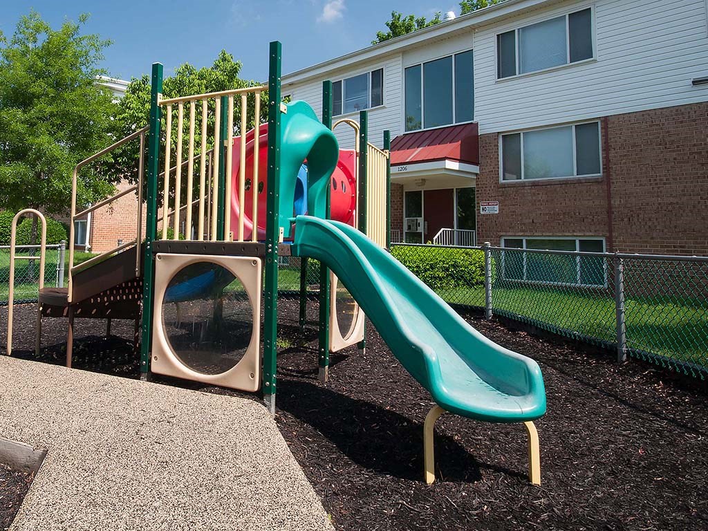 a playground with a slide and a climbing frame