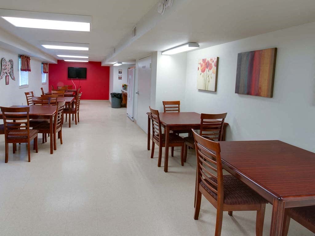 a dining room with tables and chairs in a hall
