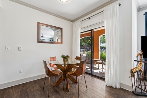 A dining room with a glass table and chairs.