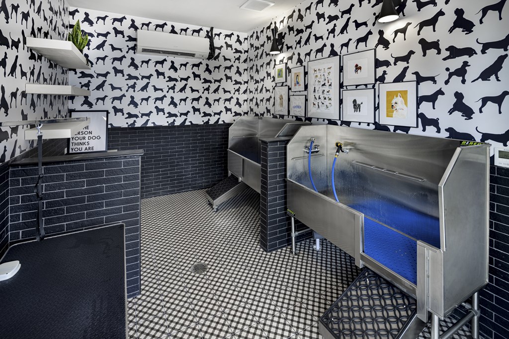 A room with a black and white checkered floor and a wall covered in black and white animal prints at Folksong Apartments, Flowery Branch, 30542
