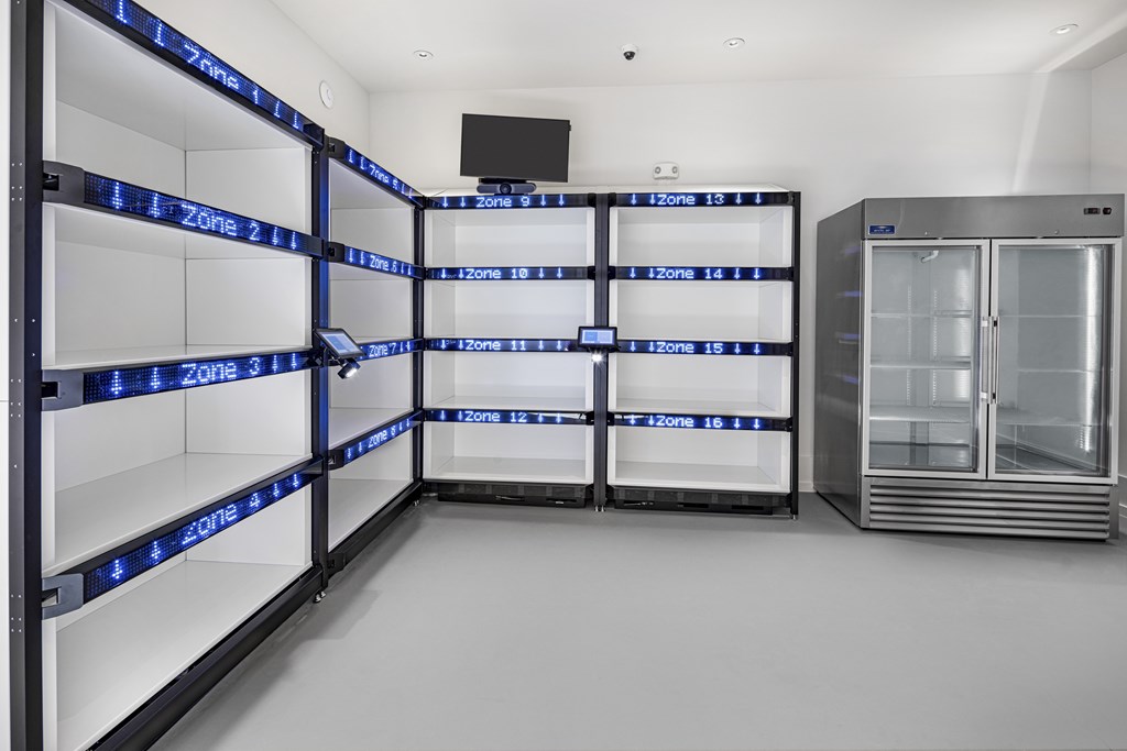 A series of refrigerators are lined up in a row with zone numbers on the shelves at Folksong Apartments, Georgia 30542