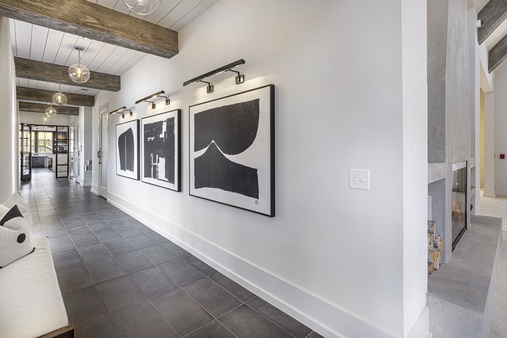 Three black and white paintings hang on a white wall at Folksong Apartments, Flowery Branch, 30542