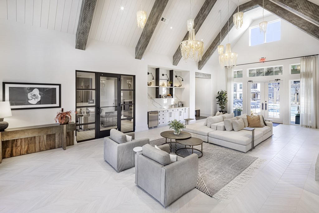 A spacious living room with a high ceiling and a large window at Folksong Apartments, Flowery Branch