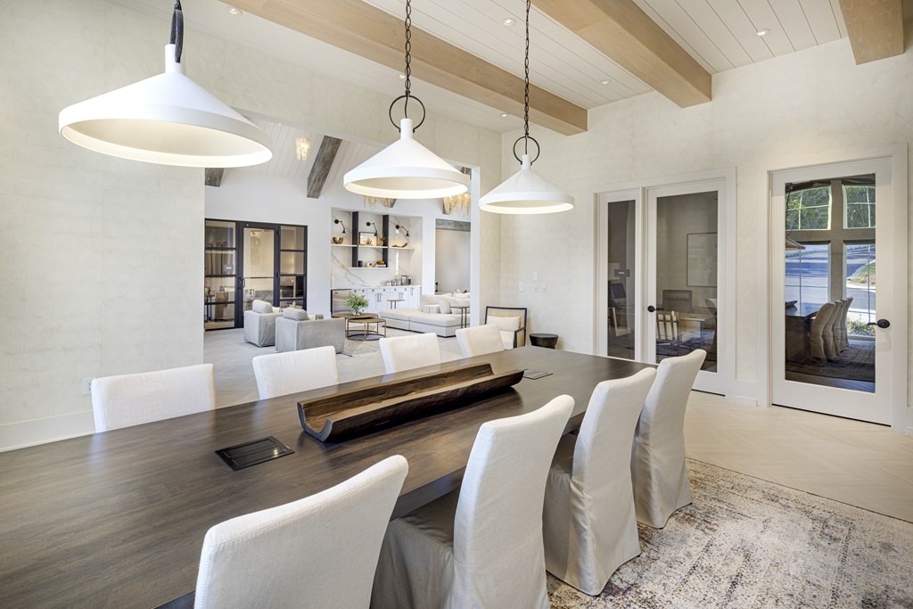 A modern dining room with a long table and chairs at Folksong Apartments, Georgia
