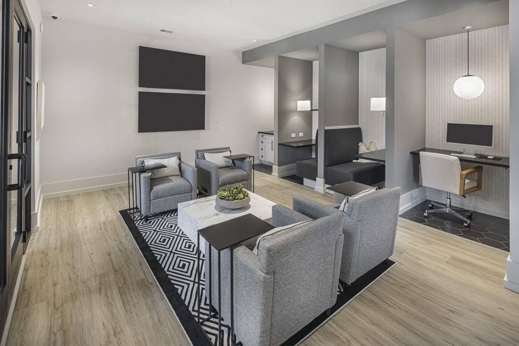 A modern living room with grey furniture and a black and white rug at Folksong Apartments, Georgia 30542