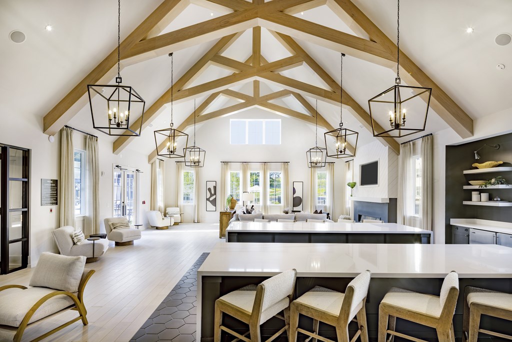 A modern kitchen with a large island and wooden beams on the ceiling at Folksong Apartments, Flowery Branch, Georgia