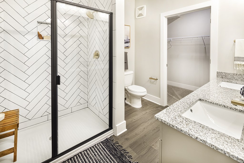 A bathroom with a walk-in shower and a toilet at Folksong Apartments, Flowery Branch, GA 30542