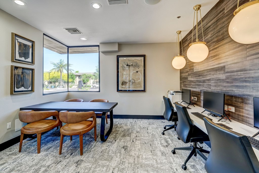 a conference room with a ping pong table and a desk with a desktop computer