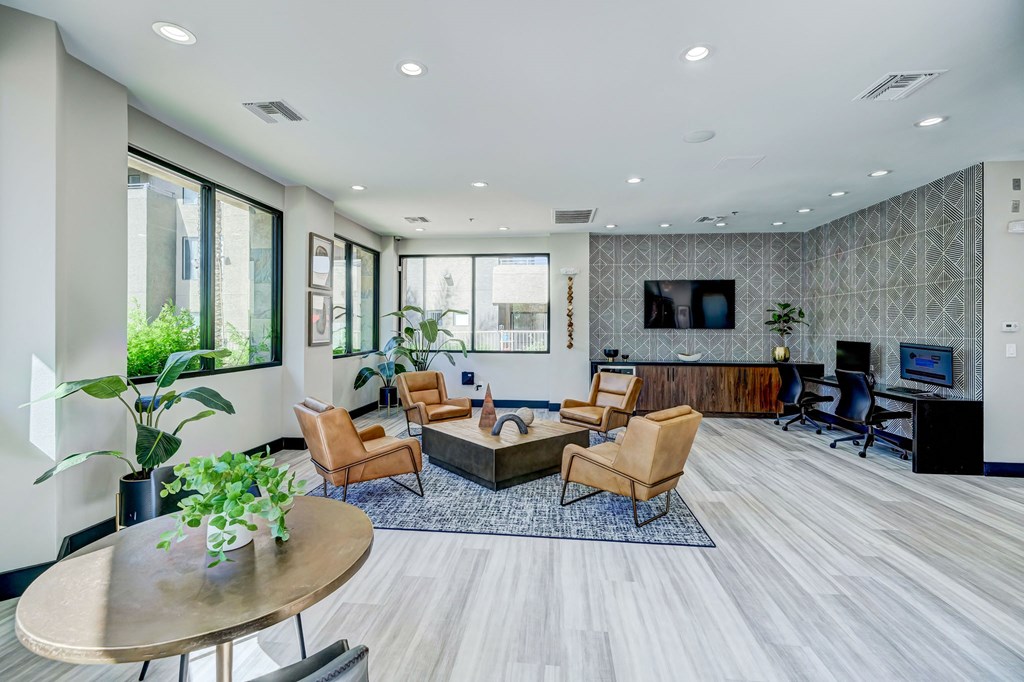 a living room with a couch and chairs and a tv