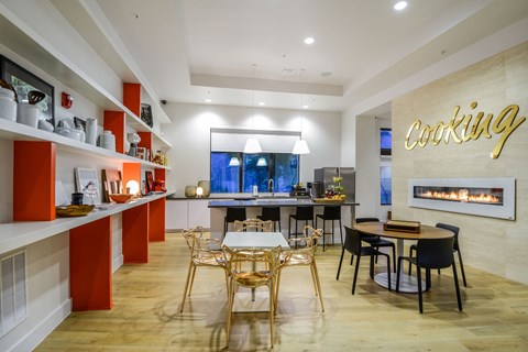 A modern kitchen with a dining table and chairs.