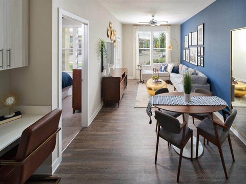 a living room and dining room with a couch and a table