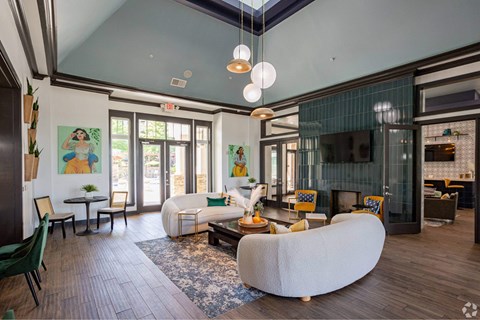a living room with couches and chairs and a fireplace