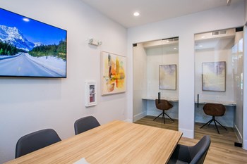 Lyric Apartments Clubhouse Lounge with Table and Desks Lyric Apartments Clubhouse Lounge with Table and Desks - Photo Gallery 6