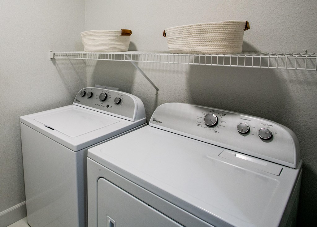 Lyric Apartments washer and dryer sit next to each other in a laundry room at Lyric Apartments, Las Vegas, NV