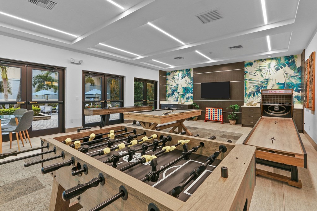 The Preserve at Westchase Apartments game room with game tables