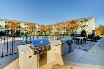 the preserve at ballantyne commons community patio with two bbq grills and tables