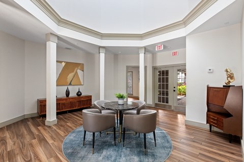 A dining room with a round table and chairs.