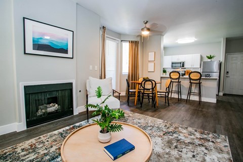 A living room with a fireplace and a painting on the wall.