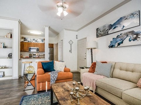 A living room with a brown wooden coffee table and two couches.