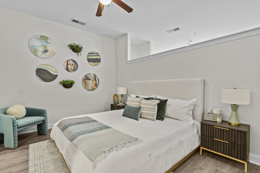 a bedroom with a large bed and a ceiling fan