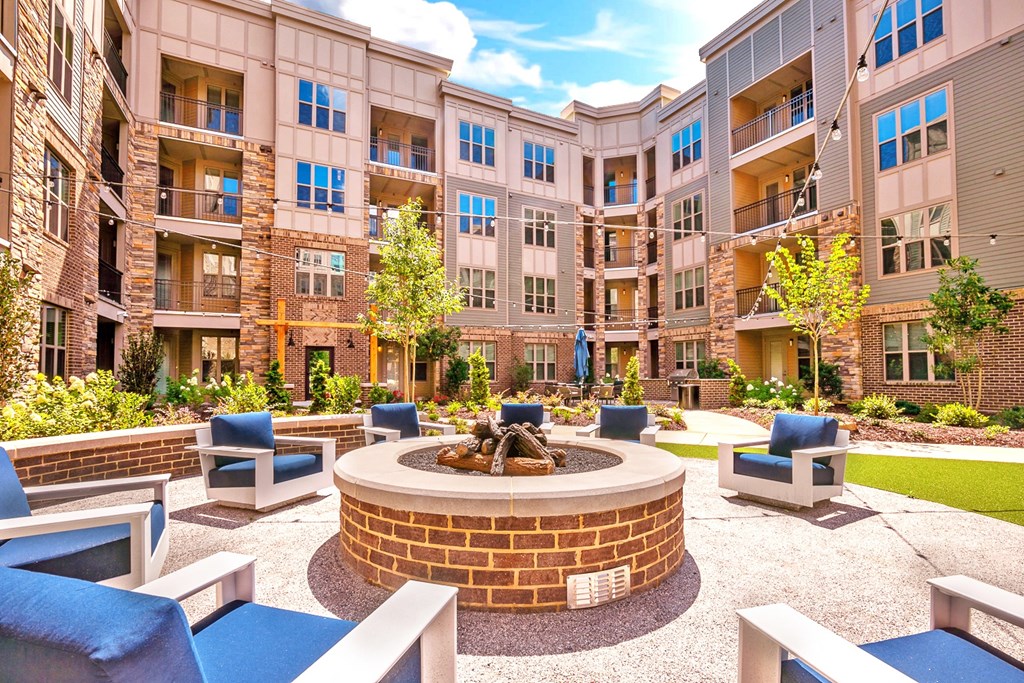 an outdoor courtyard with a fire pit and lounge chairs at Artesia Big Creek, Alpharetta, GA, 30005